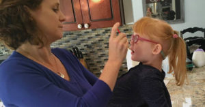 Jana Adams administers a tincture high in CBD to her daughter, Brooke, who has Dravet Syndrome.